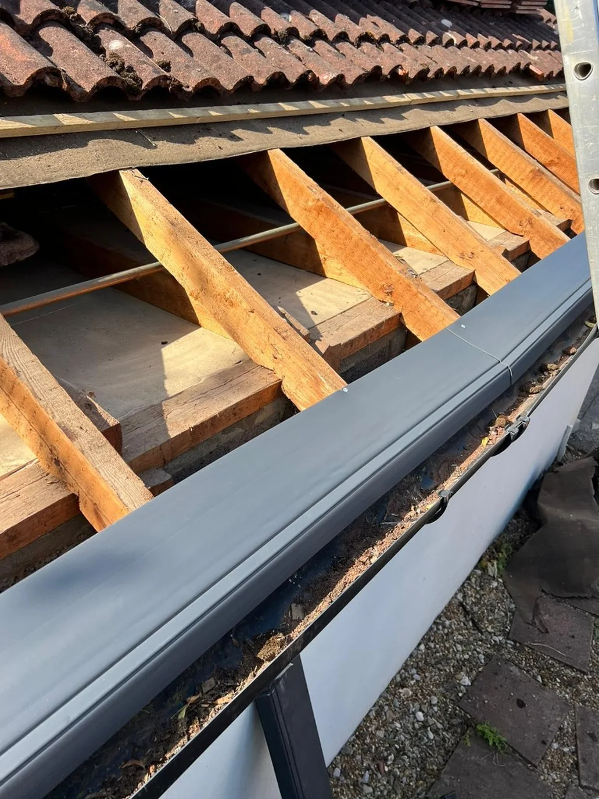 eaves support trays fitted over rafters and membrane above white fascia and guttering in Alton — Mitchell's Roofing