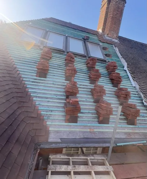 new clay tile roof with skylights, membrane and battens during professional installation in Guildford — Mitchell's Roofing