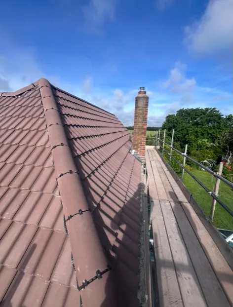 residential roof tiling in progress with membrane, battens and scaffolding in Camberley — Mitchell's Roofing