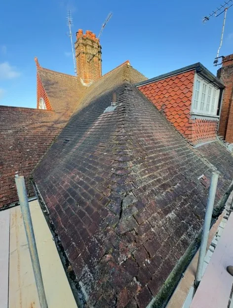 traditional clay tile roof with fish-scale dormer cheeks and brick chimney in Haslemere — Mitchell's Roofing